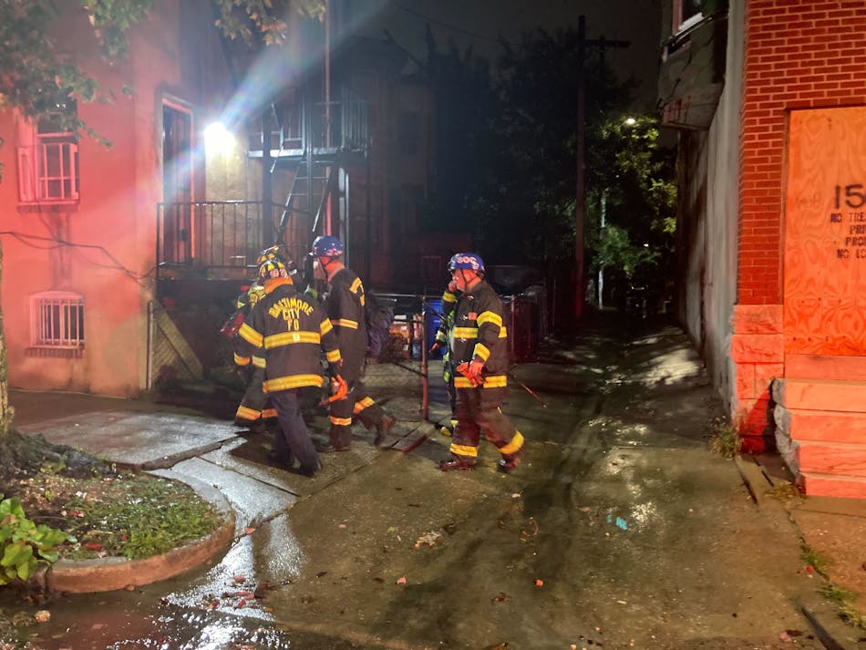 Baltimore firefighters rescued a man who fell through a floor of a partially collapsed house.