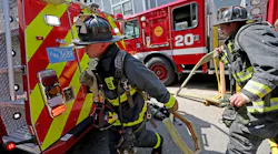 Boston firefighters grab a line at a recent house fire.