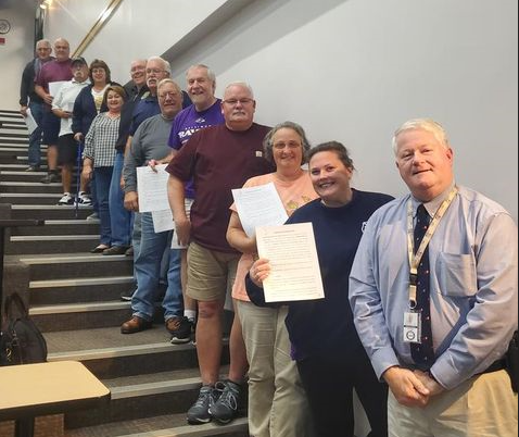 Director Mike Robinson stands with volunteers who signed an MOU with the county.