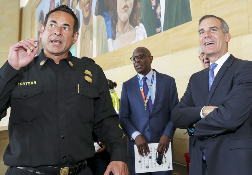 Ex-LA Asst. Chief Ellsworth Fortman, left, and Mayor Eric Garcetti talk.