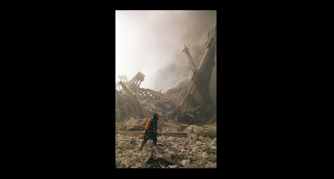 An FDNY firefighter works in the rubble of the World Trade Center.