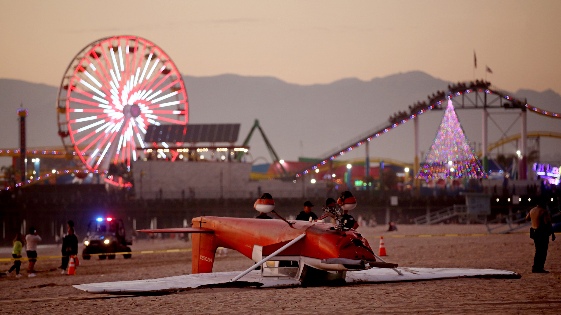 An investigation in underway as a single-engine Cessna airplane flipped over after the pilot landed on the beach south of the pier on Thursday, Dec. 22, 2022, in Santa Monica, California. Both occupants were rescued and transported to a hospital.