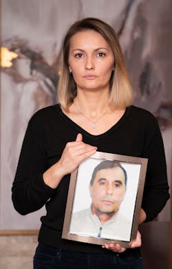 Nika Frasheri Sopiqoti is pictured with a portrait of her father Genci Frasheri. Nika Frasheri Sopiqoti is pictured with a portrait of her father Genci Frasheri.