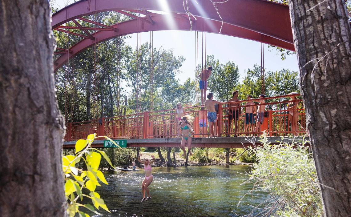People jump from the Red Bridge.