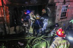 An Atlanta firefighter slipped into a hole at a house fire.