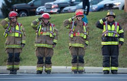 Local firefighters salute as the hearses carrying the bodies of fallen colleagues pass. Local firefighters salute as the hearses carrying the bodies of fallen colleagues pass.