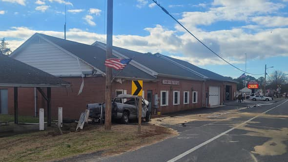 The truck hit posts near the firehouse.