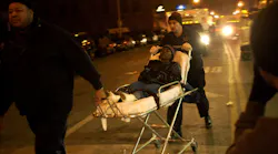 A victim is rushed to an ambulance,