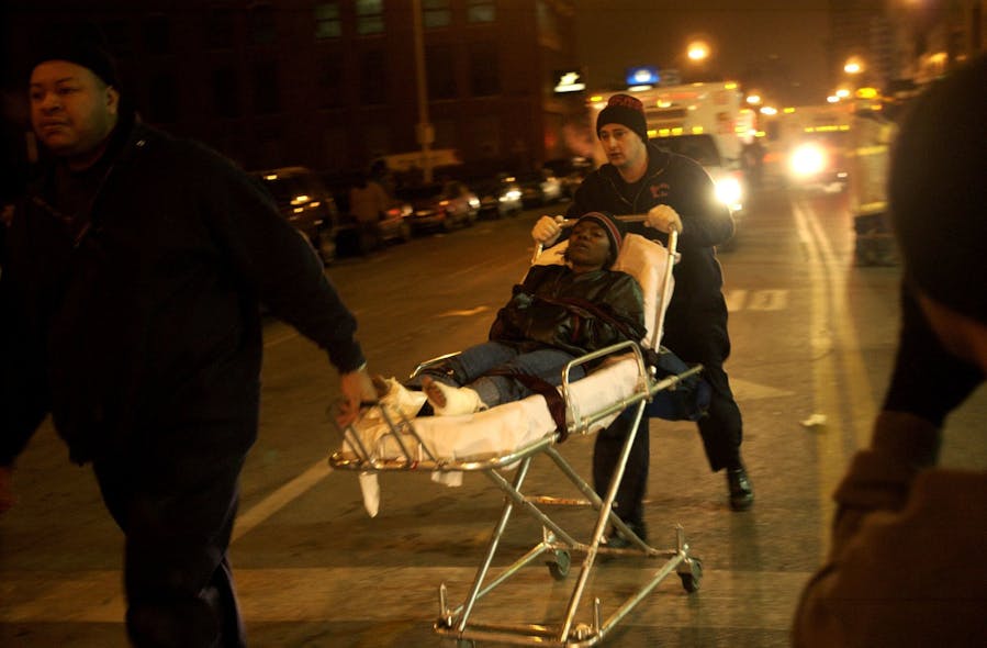 A victim is rushed to an ambulance, A victim is rushed to an ambulance,