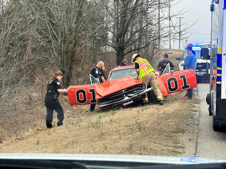 Firefighters, EMS crews and officers examine the scene.