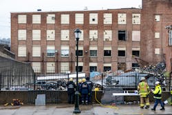 Rescuers look over the scene of the collapsed factory in West Reading Saturday, Rescuers look over the scene of the collapsed factory in West Reading Saturday,