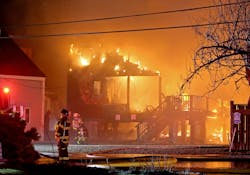 Homes burn during a five-alarm fire in the Minot beach section of Scituate Friday night. Homes burn during a five-alarm fire in the Minot beach section of Scituate Friday night.