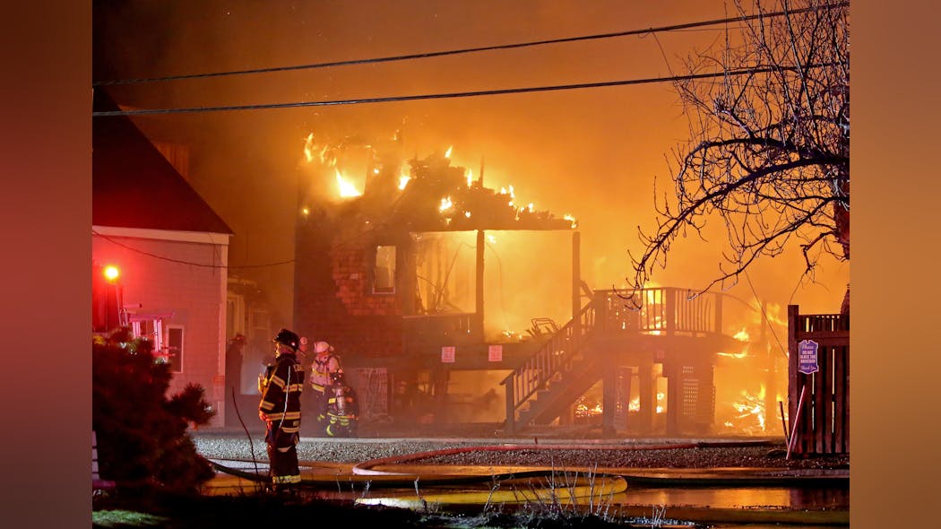 Homes burn during a five-alarm fire in the Minot beach section of Scituate Friday night. Homes burn during a five-alarm fire in the Minot beach section of Scituate Friday night.