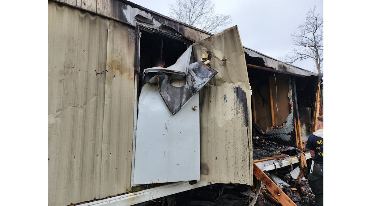 The explosion of the oxygen tank bent the rear door of the mobile home half over itself.