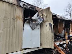 The explosion of the oxygen tank bent the rear door of the mobile home half over itself. The explosion of the oxygen tank bent the rear door of the mobile home half over itself.