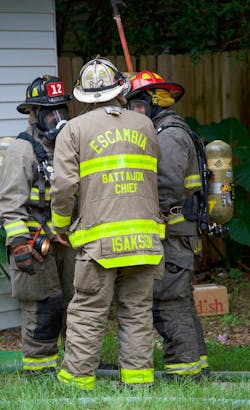 The fireground commander that’s operating in the front yard (based on arrival sequence and limited staffing) is identified easily, as is the company officer in the red helmet and the firefighter that’s assigned to Ladder 12. Notice that the firefighter’s last name is on both the helmet front piece and the mask piece. The fireground commander that’s operating in the front yard (based on arrival sequence and limited staffing) is identified easily, as is the company officer in the red helmet and the firefighter that’s assigned to Ladder 12. Notice that the firefighter’s last name is on both the helmet front piece and the mask piece.