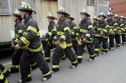 FDNY recruits marching at training academy.