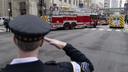 A Chicago police officer salutes as an ambulance carrying the body of fallen Chicago firefighter Lt. Jan Tchoryk departs Northwestern Memorial Hospital on April 5. A Chicago police officer salutes as an ambulance carrying the body of fallen Chicago firefighter Lt. Jan Tchoryk departs Northwestern Memorial Hospital on April 5.