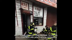 Engine company firefighters await orders from crews searching for the fire in the commercial building. Engine company firefighters await orders from crews searching for the fire in the commercial building.