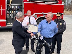 Harvard Fire Department firefighter and drone operator Robert Curran receives the TEAM Award from Worcester County District Attorney Joseph Early Jr.