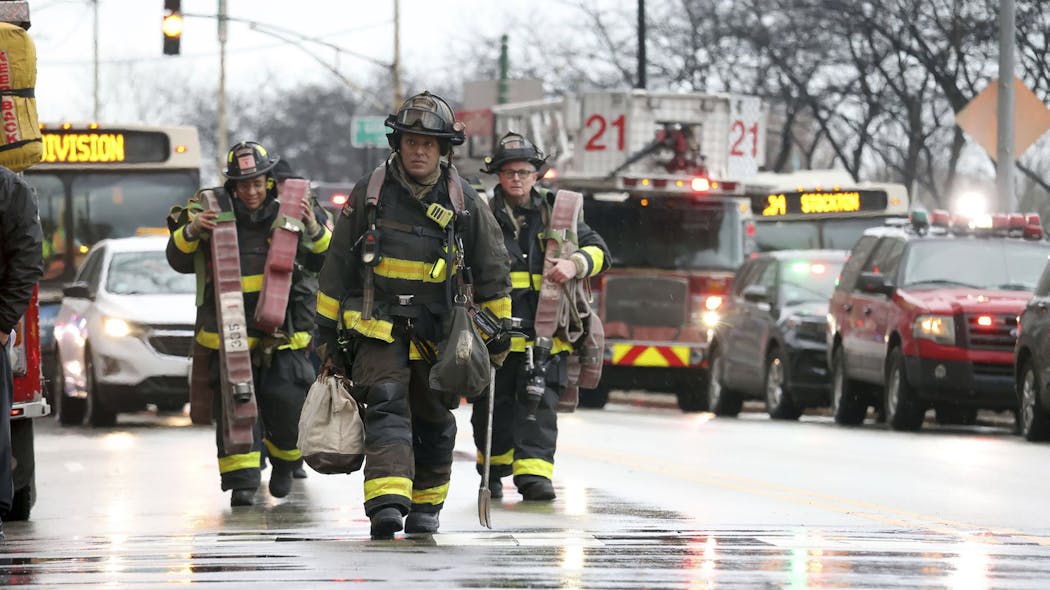 With elevators inoperable, Chicago firefighters had to haul gear up to the 27th floor. With elevators inoperable, Chicago firefighters had to haul gear up to the 27th floor.