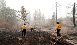 In this file photo, firefighters put out burning embers in the Fresno County community of Bald Mountain, in the foothills of the Sierra Nevada mountains, on Sept. 11, 2020. In this file photo, firefighters put out burning embers in the Fresno County community of Bald Mountain, in the foothills of the Sierra Nevada mountains, on Sept. 11, 2020.