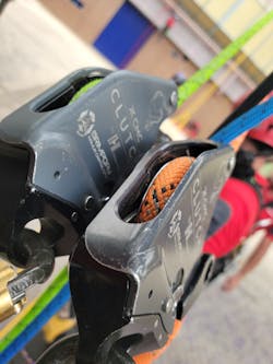 In a circumstance in which a CMC clutch is being used in a twin tension rope system (TTRS), a rigging plate is attached using Kong DNA twist carabiners, which puts the devices in a vertical orientation to allow a single user to operate the levers of both devices. The rope is 11mm Sterling Sync, which is NFPA G-rated. In a circumstance in which a CMC clutch is being used in a twin tension rope system (TTRS), a rigging plate is attached using Kong DNA twist carabiners, which puts the devices in a vertical orientation to allow a single user to operate the levers of both devices. The rope is 11mm Sterling Sync, which is NFPA G-rated.