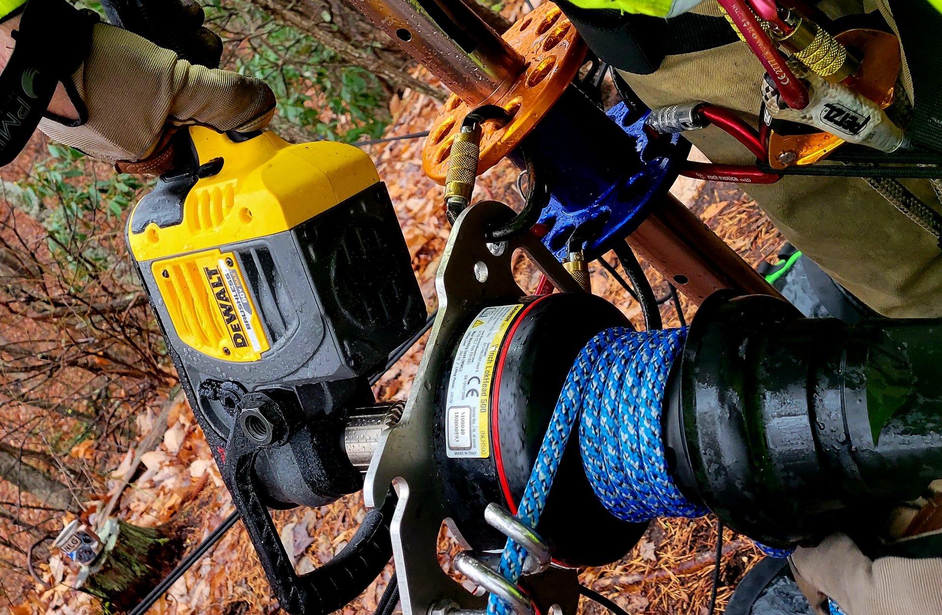Teams that have long hauling systems, limited staffing and/or continual operations might find that using a winch/drill combination makes raising and lowering easier. Here, a Harken LokHead winch is powered by a 60-volt cordless drill. A winch/drill combination can reduce dynamic forces through uneven hauling. The line that&rsquo;s shown is Courant 11mm Rebel low-stretch static kernmantle rope.