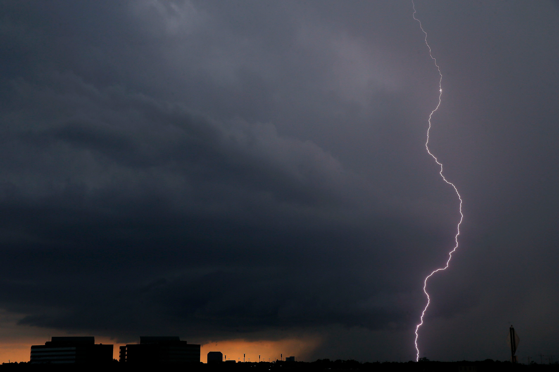 A lightning bolt from a thunderstorm strikes down in Irving, Texas, Thursday, June 7, 2018.
