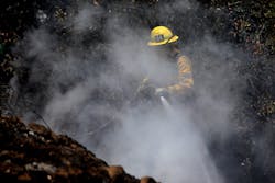 A Los Angeles firefighter hits hotspots. A Los Angeles firefighter hits hotspots.