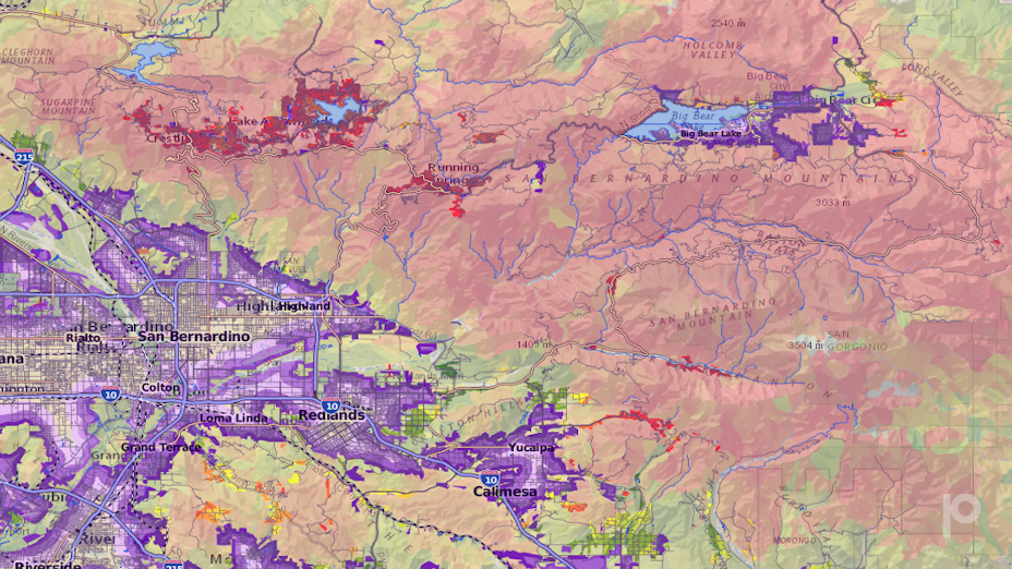 Precisely provides San Bernardino County with pro bono access to its Wildfire Risk solution, offering a detailed assessment of wildfire severity and probability in the region. Image shows analysis spanning the city's edge to the mountain rim and throughout the desert areas of the County. Color-coding on the image represents different types of threats. Purple areas denote locations where embers are the primary threat (which typically happens in transition zones between wildlands and urban areas). Dark red areas indicate where there is high densities of homes or communities which have been rated as &ldquo;very high&rdquo; for risk. The muted colors show wildland areas where homes are more widely spaced out or indicate areas of the National Forest.