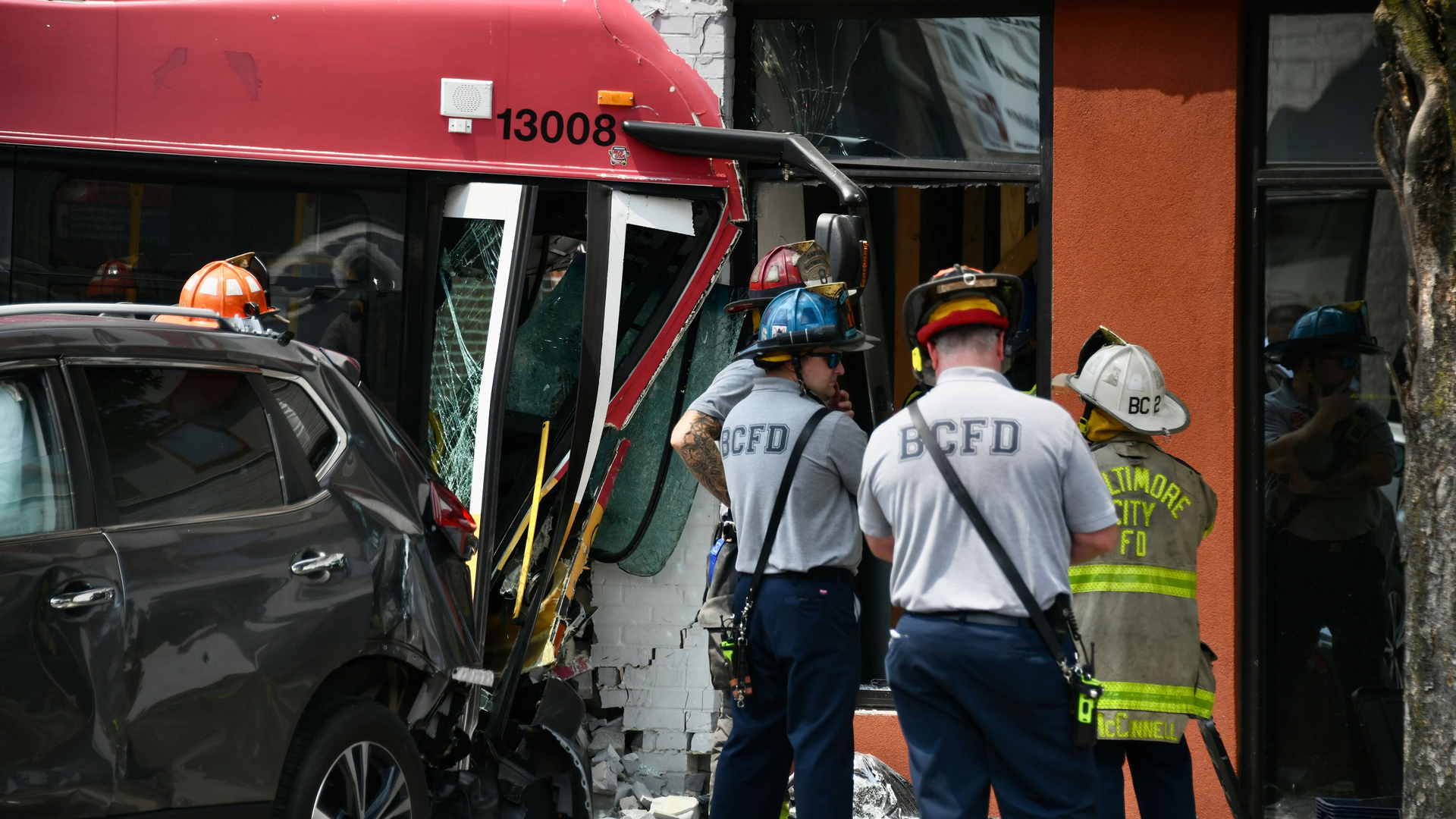 Firefighters at the scene of a multi-vehicle crash that involved an MTA bus and two other cars in Baltimore Saturday.