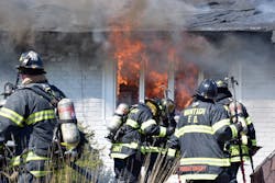 After knocking down the automobile and garage fire, a crew that advanced a hoseline through the front door was in the process of attacking the fire in the house when an explosion occurred.
