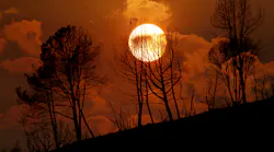 The sun sets on ridge during the Oak fire in 2022.