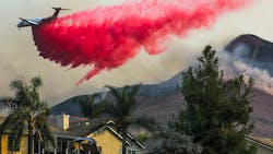 CHINO HILLS, CA - OCTOBER 27: Air tanker makes fire retardant drop behind homes on Tuesday, Oct. 27, 2020 in Chino Hills, CA. CHINO HILLS, CA - OCTOBER 27: Air tanker makes fire retardant drop behind homes on Tuesday, Oct. 27, 2020 in Chino Hills, CA.