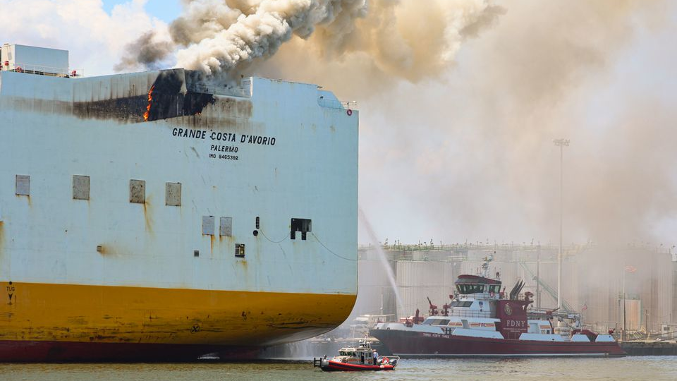 Fire continues to burn aboard the cargo ship Grande Costa D Avorio where two Newark firefighters were killed.