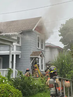 Firefighters from Engine 10 prepare to stretch a hose line into the house at 109 Helen St. Two Hose lines are already operating inside at this point in the incident. Engine 10’s job is to get above the fire room, in this case into the attic, to ensure that the fire has not spread to that part of the building.