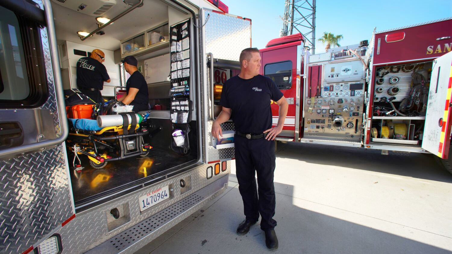 San Diego County Fire Engineer Paramedic Trey Nelson, waits outside the ambulance as firefighters, Robert Amaya (left) and Fernando Ayala (right) check medical supplies at the new San Diego County Station 60 in Borrego Springs, CA.