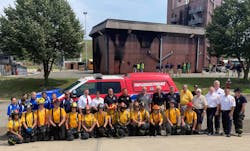 The 'Yellow Team' poses with staff members upon completion of their car fire drill. The 'Yellow Team' poses with staff members upon completion of their car fire drill.