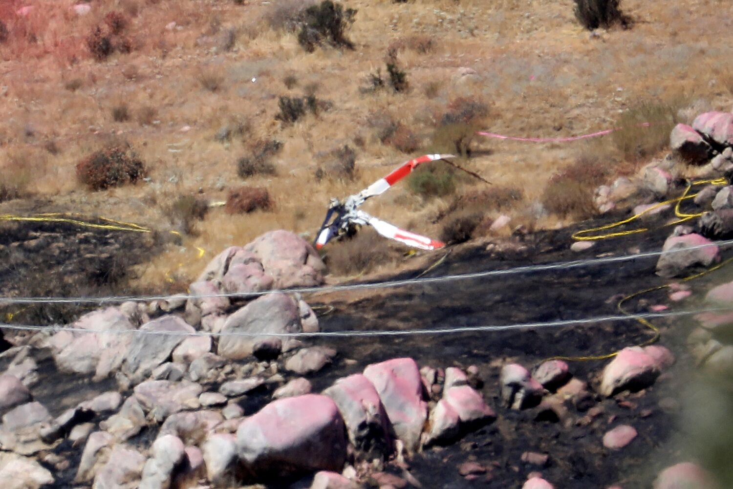 A mid-air collision claimed two firefighters and the pilot of one helicopter.