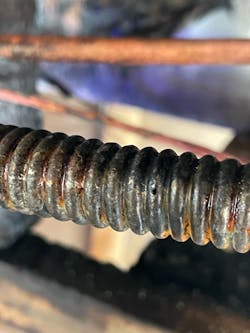 The lightning-induced pinhole in the CSST in the space below the floor of the second floor and above the ceiling of the first floor. The lightning-induced pinhole in the CSST in the space below the floor of the second floor and above the ceiling of the first floor.