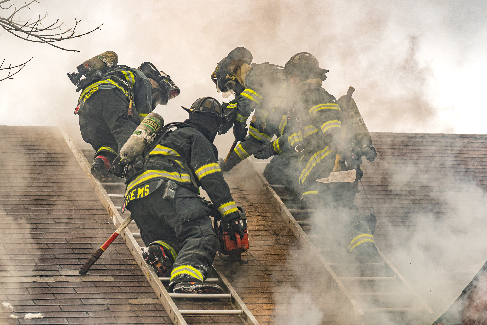 In the process of carrying out a Milwaukee cut, a firefighter on each of two roof ladders starts by cutting an approximately four-foot vertical seam that runs parallel to each ladder beam that&rsquo;s closest to the hole location.