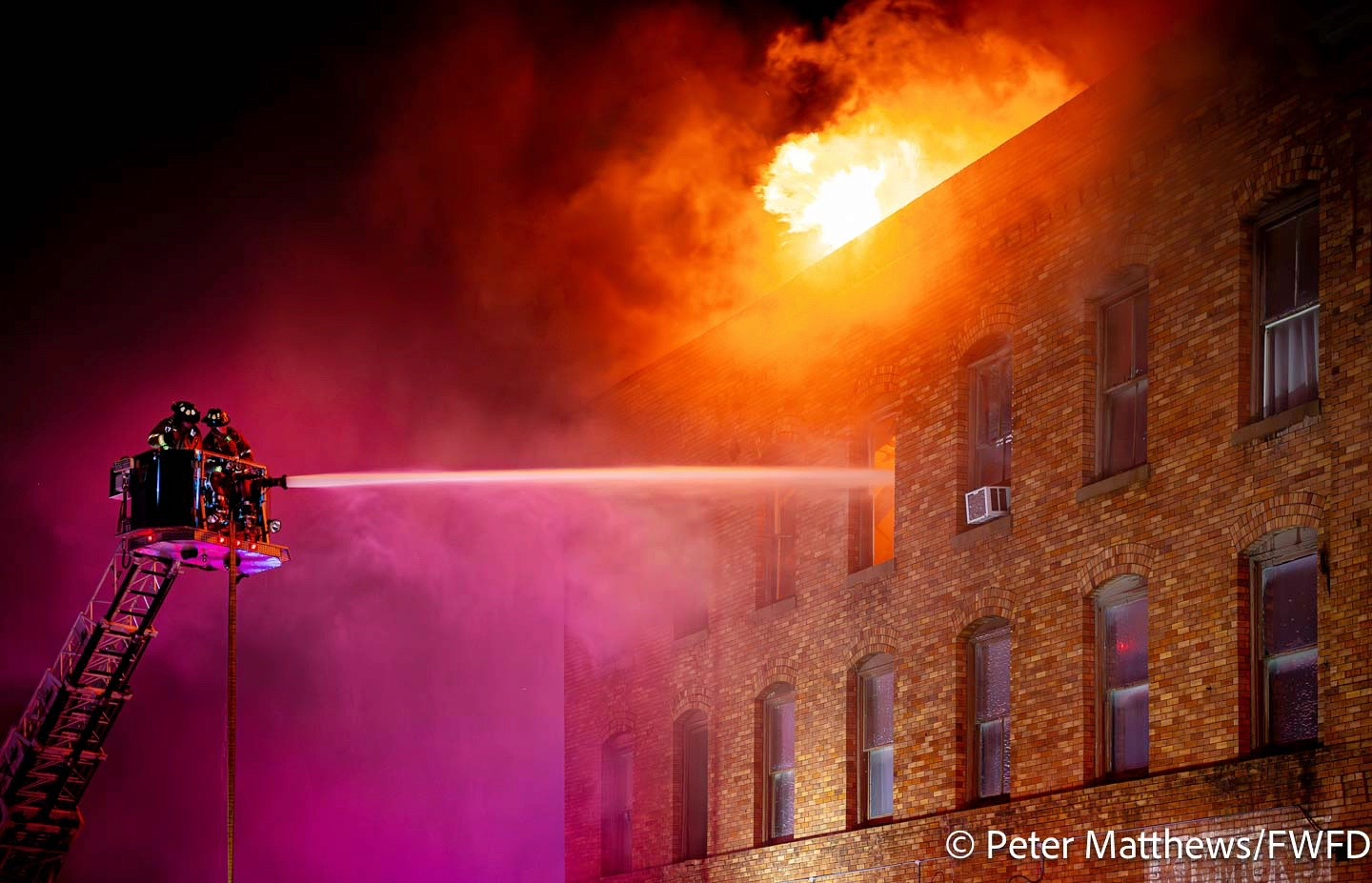 Fire spread from the basement to the top floor of the four-story building, and broke through the roof.
