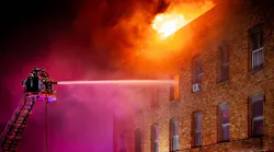 Fire spread from the basement to the top floor of the four-story building, and broke through the roof.