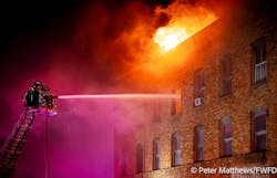 Fire spread from the basement to the top floor of the four-story building, and broke through the roof. Fire spread from the basement to the top floor of the four-story building, and broke through the roof.