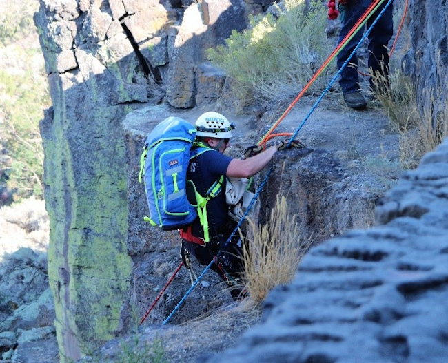 A Magic Valley Paramedics’ Special Operations Reach and Treat (SORT) team member is lowered over the side of the Snake River Canyon to begin to treat an injured hiker.