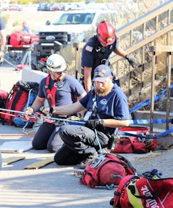 Two SORT team members manage rope systems during a rescue while supported by a Twin Falls Fire Department (TFFD) firefighter. Two SORT team members manage rope systems during a rescue while supported by a Twin Falls Fire Department (TFFD) firefighter.