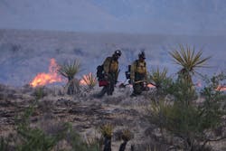 Crane Valley Hotshot firefighters walk as the York Fire burns in the Mojave National Preserve on July 30. Crane Valley Hotshot firefighters walk as the York Fire burns in the Mojave National Preserve on July 30.
