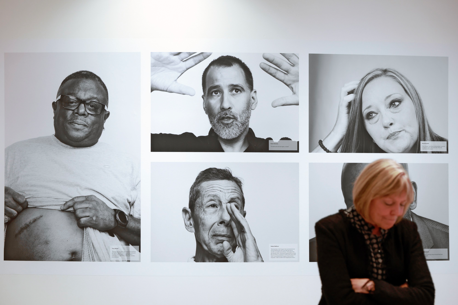 CDC Museum Director Judy Gantt stands in front of portraits of members of the WTC Health Program at 'The Health Effects of 9/11' exhibit at The David J. Sencer CDC Museum.