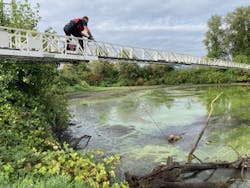 A Portland firefighter walks across a ladder to the escapee who was stuck in the mud. A Portland firefighter walks across a ladder to the escapee who was stuck in the mud.